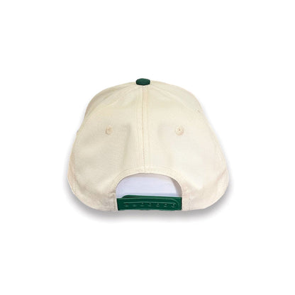 Urban Cowboy Co. The Pathfinder snapback hat featuring a beige crown, green adjustable strap, and green top button.